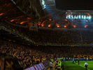 Football fans cheering in a packed stadium atmosphere