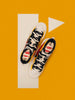 Pair of black and white high-top trainers on a bright orange background