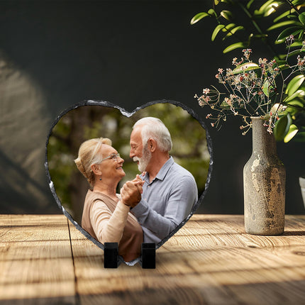 Freestanding heart-shaped photo slate displaying a family photograph on a wooden shelf