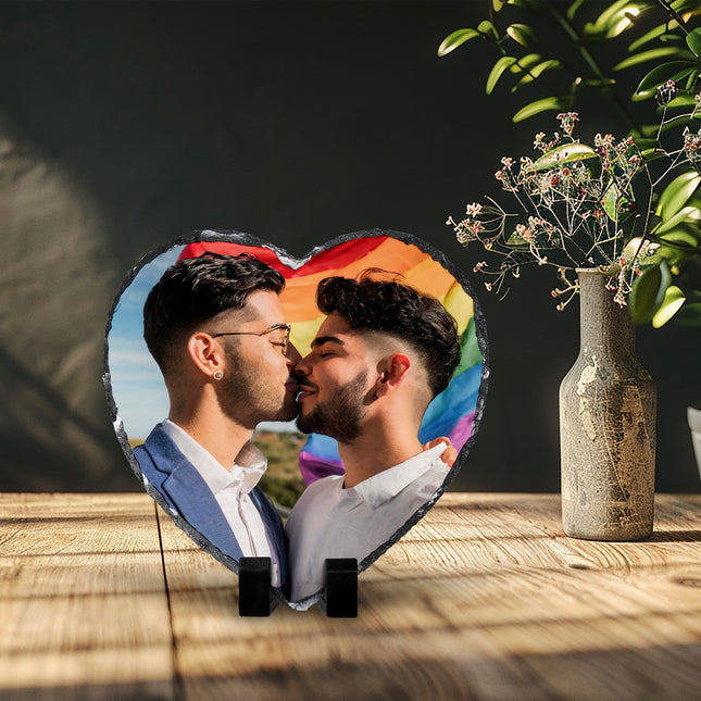 Freestanding heart-shaped photo slate displaying a couple photograph on a wooden shelf