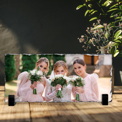 Freestanding rectangular photo slate displaying a wedding photograph on a wooden shelf