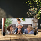 Freestanding rectangular photo slate displaying a family photograph on a wooden shelf